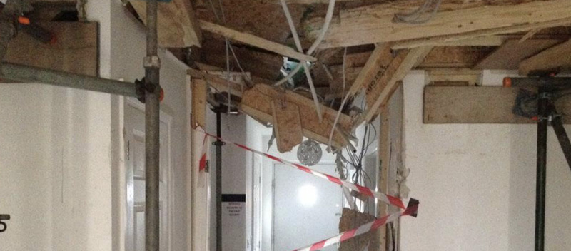Crane collapses and crashes through a property
