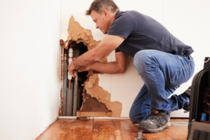 Burst pipe in property wall.