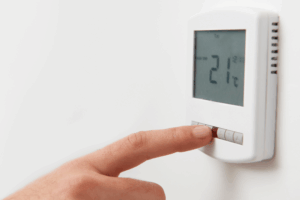 Adjusting the thermostat.