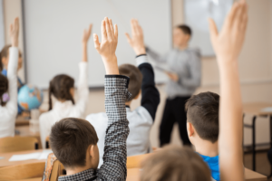Children in School raising hands