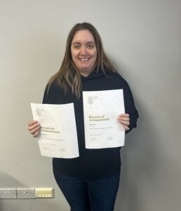 Kelly Carr holding certificates